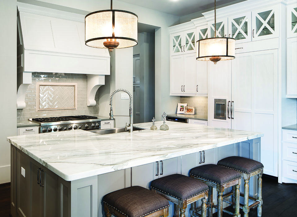 A KITCHEN USING BOTH NATURAL STONE AND ENGINEERED QUARTZ.